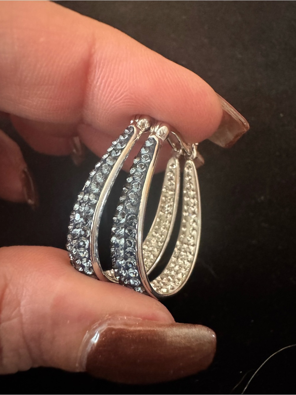 Silver tone oval inside-out crystal pave hoop earrings with blue & white crystal